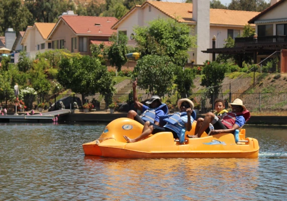 a group riding a paddle boat during our Triathalon event