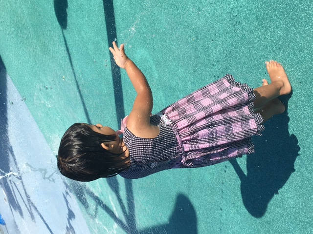 A blind little girl feeling water drop on her hand