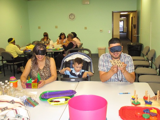 Here is a mother and father blindfolded and asked to perform tasks that will enable them to understand what it is like for their blind child.