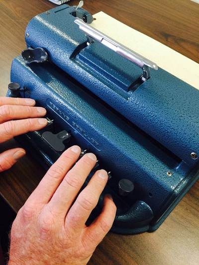 Kelly using a Perkins Braille Writer