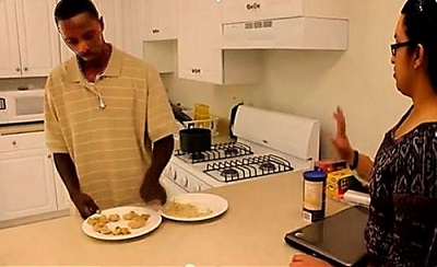 Brenda teaching James how to cook