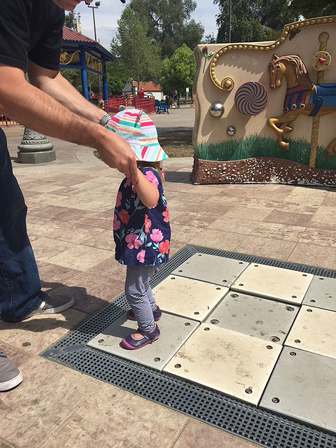 A child is playing on the musical stepping squares at the sensory playground