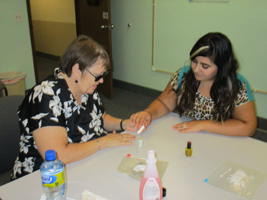 Learning how to paint your nails when you are blind by an independent living skills instructor at BSS