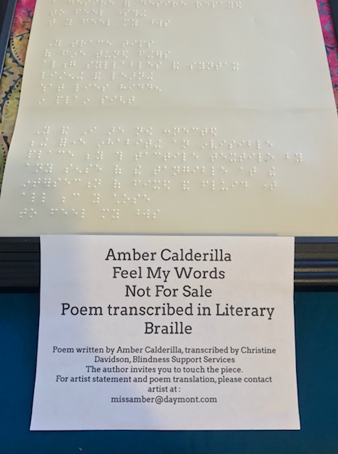close up on the information card stating Poem written by Amber Calderilla, Transcribed by Christine Davidson, Blindness Support Services. The author invites you to touch the piece